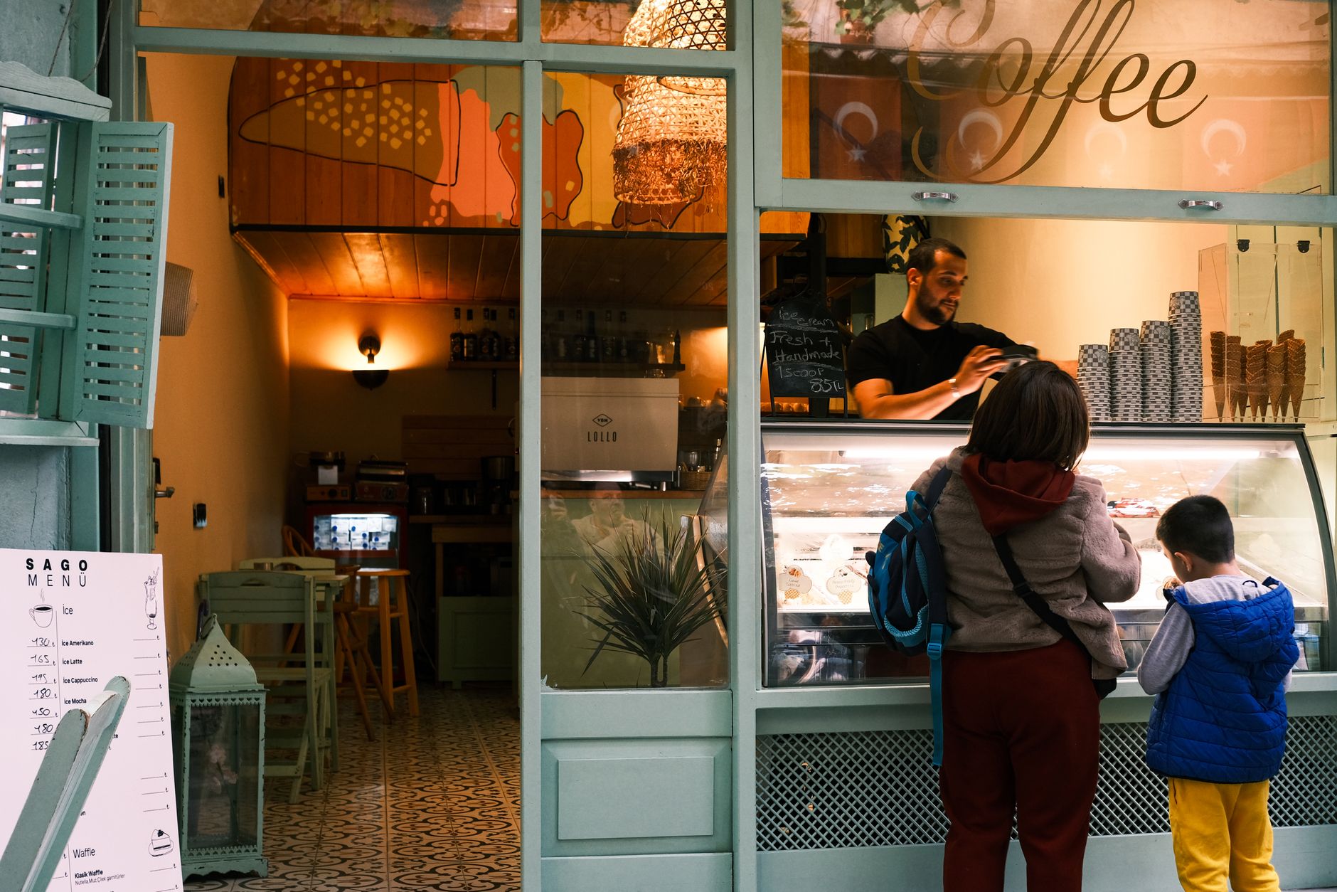 family ordering ice cream at cozy cafe